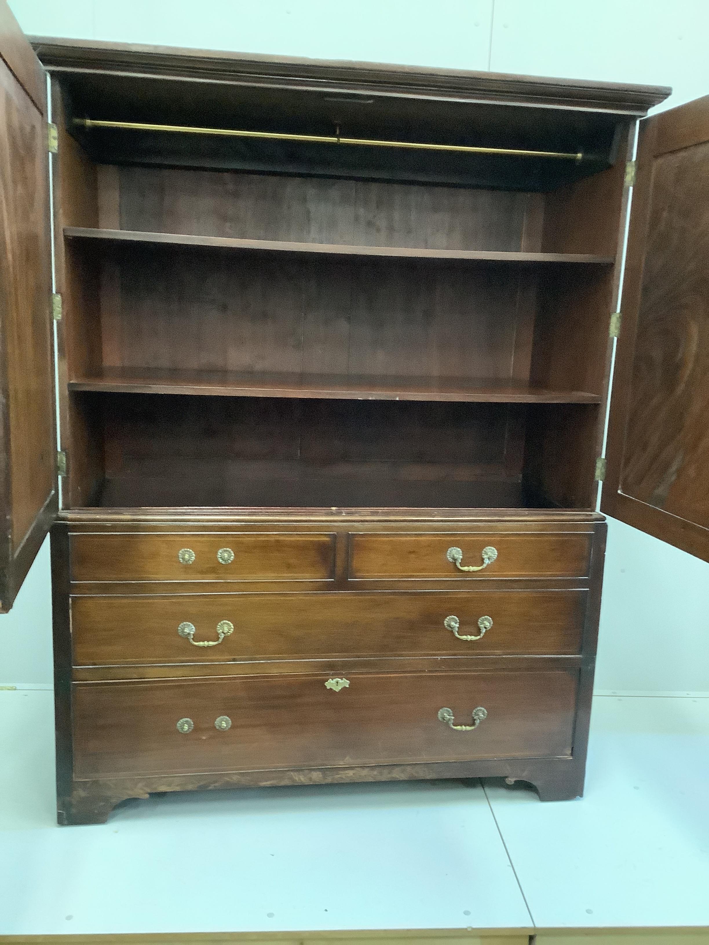 A George III mahogany linen press, converted to a hanging wardrobe, width 146cm, depth 64cm, height 186cm